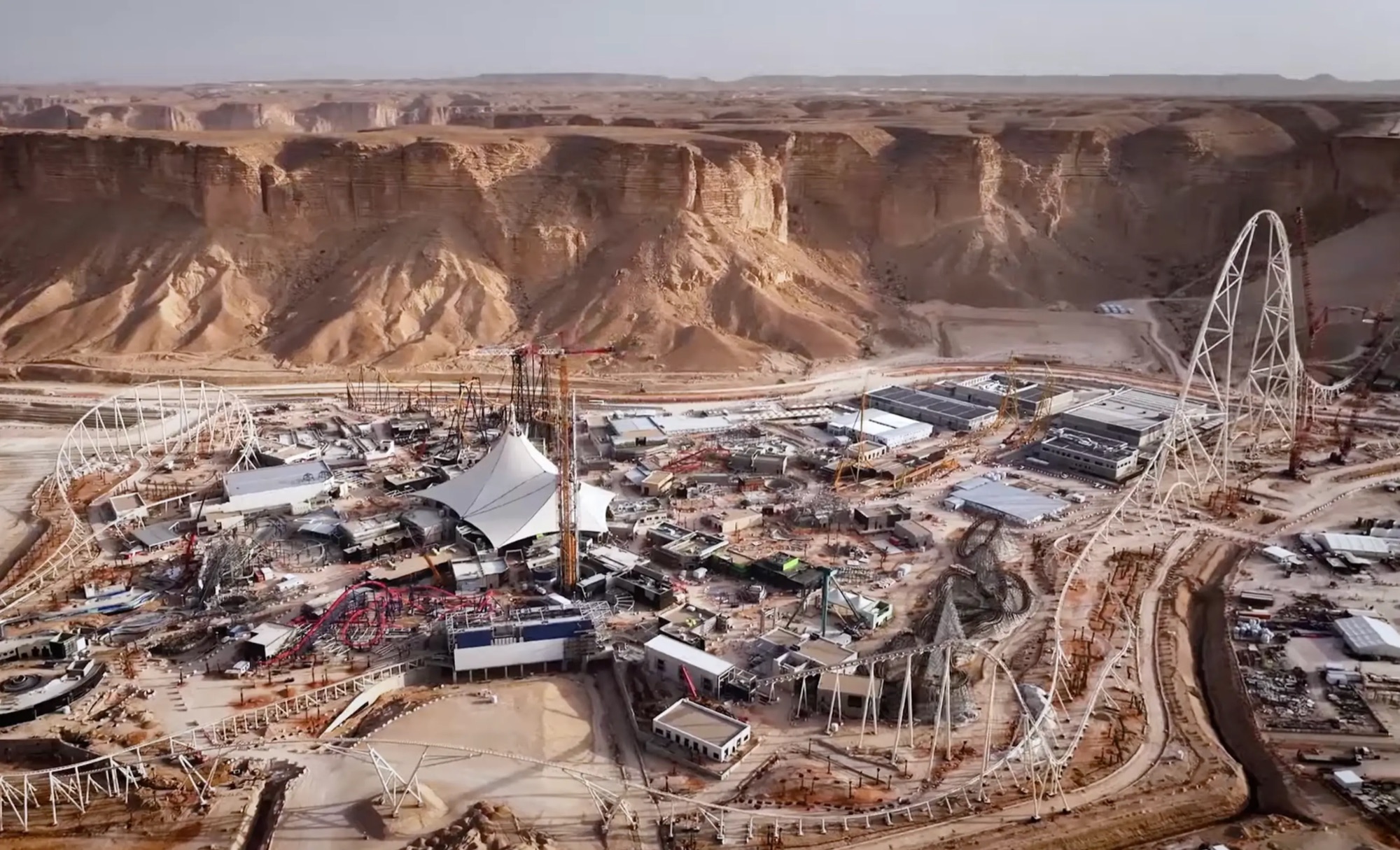 Falcons Flight's spike mid-assembly, surrounded by cranes and site cabins