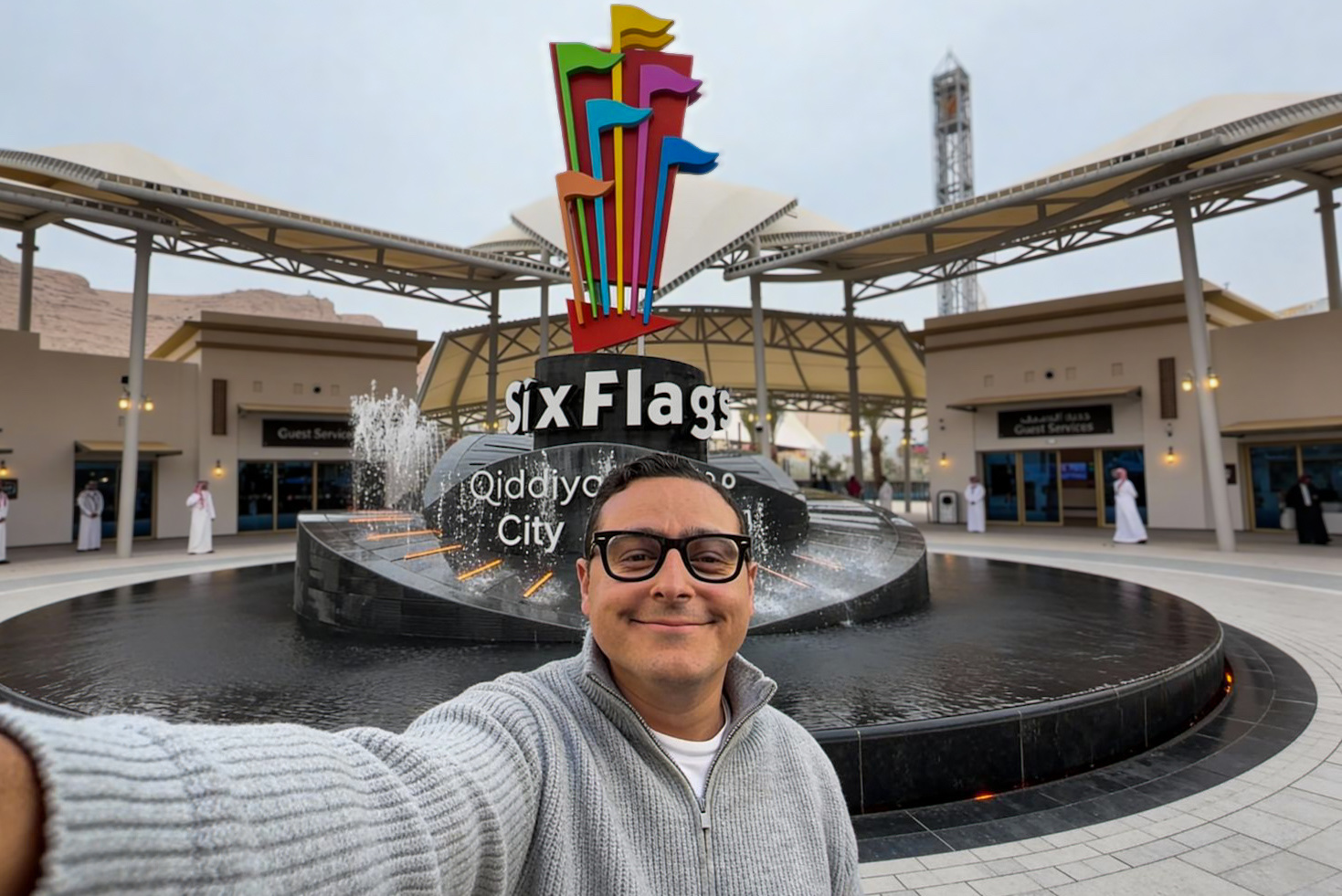 Michael Hanna at the entrance fountain of Six Flags Qiddiya City on opening day, the Six Flags sign behind him